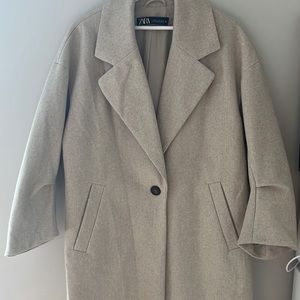 Oversized look. Great to wear over sweaters. No flaws